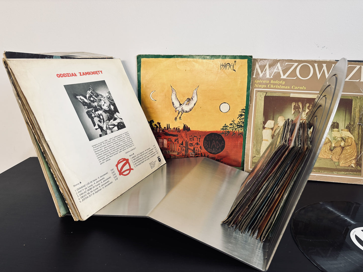 Collection of vinyl records with their covers open on a table.