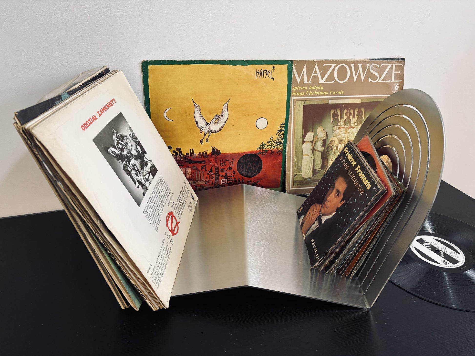 Collection of vinyl records with their covers open, showing album art and text.