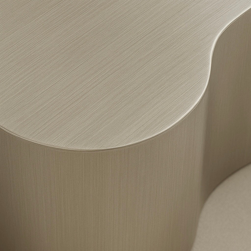 Close-up of a beige side table with a curved design