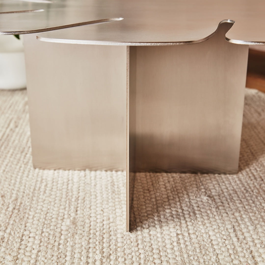 Welded stainless steel base forming a stable sculptural construction.