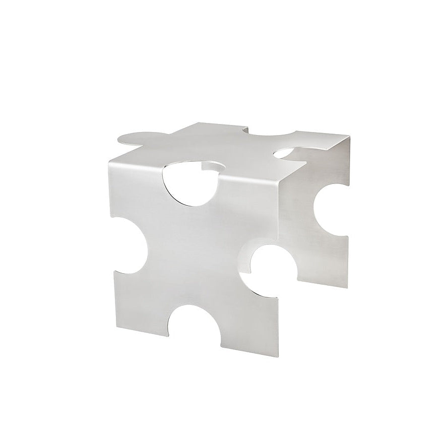 Sculptural brushed stainless steel “Puzzle Table” by Veliento — modern collectible side table with interlocking geometric form, photographed in soft neutral light against a minimalist background.
