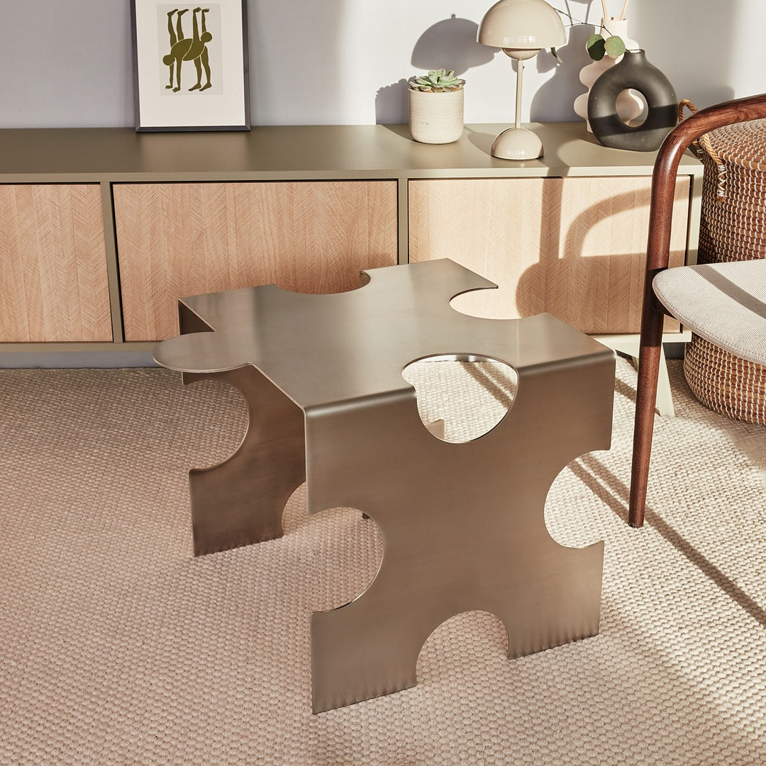 Modern metallic side table with geometric design in a room setting