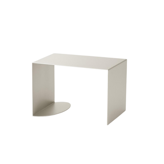 Minimalist white side table on a white background